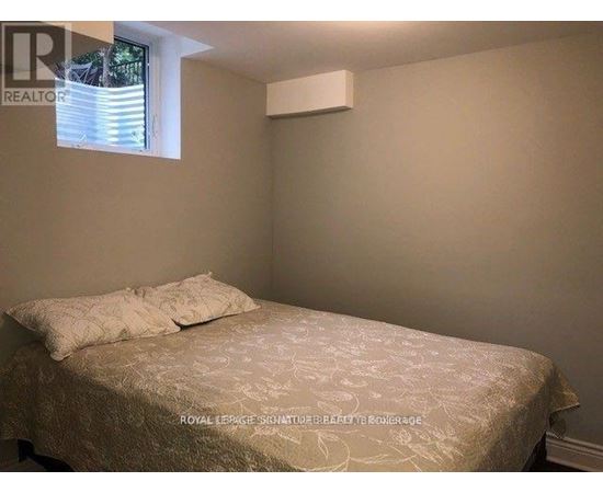 A bedroom with a bed and a window.