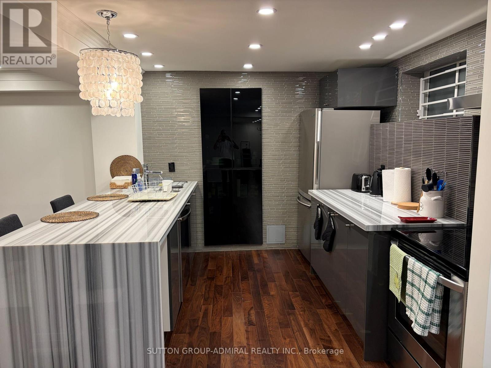 A modern kitchen with a dining table and a refrigerator.