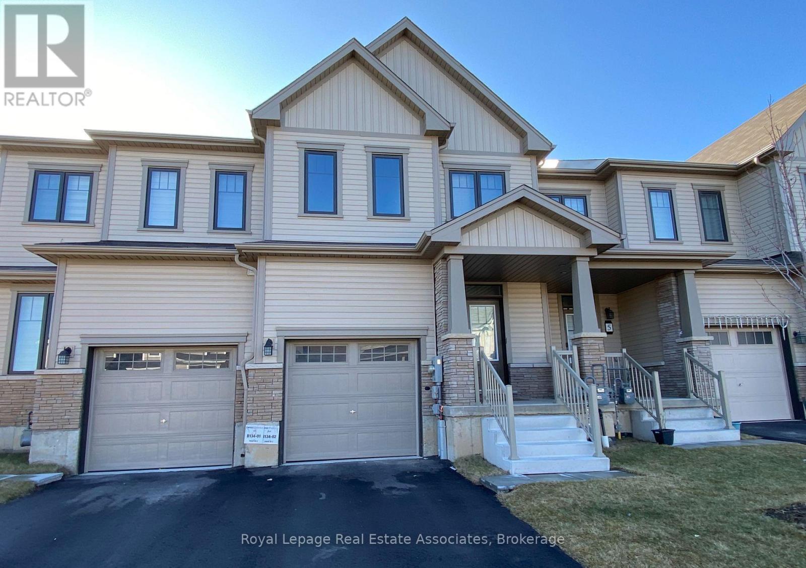 A large, two-story house with a garage is for sale.