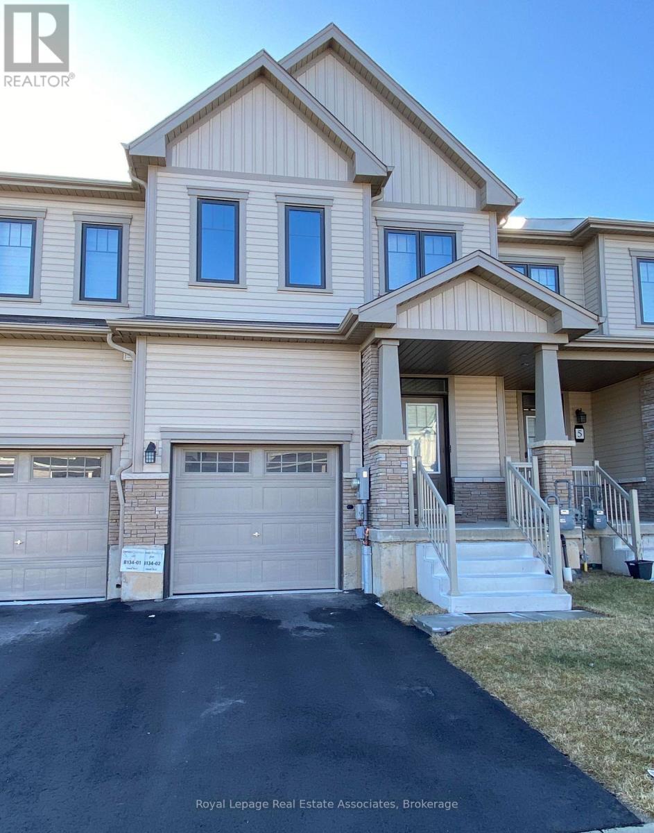 A two-story house with a garage is for sale.