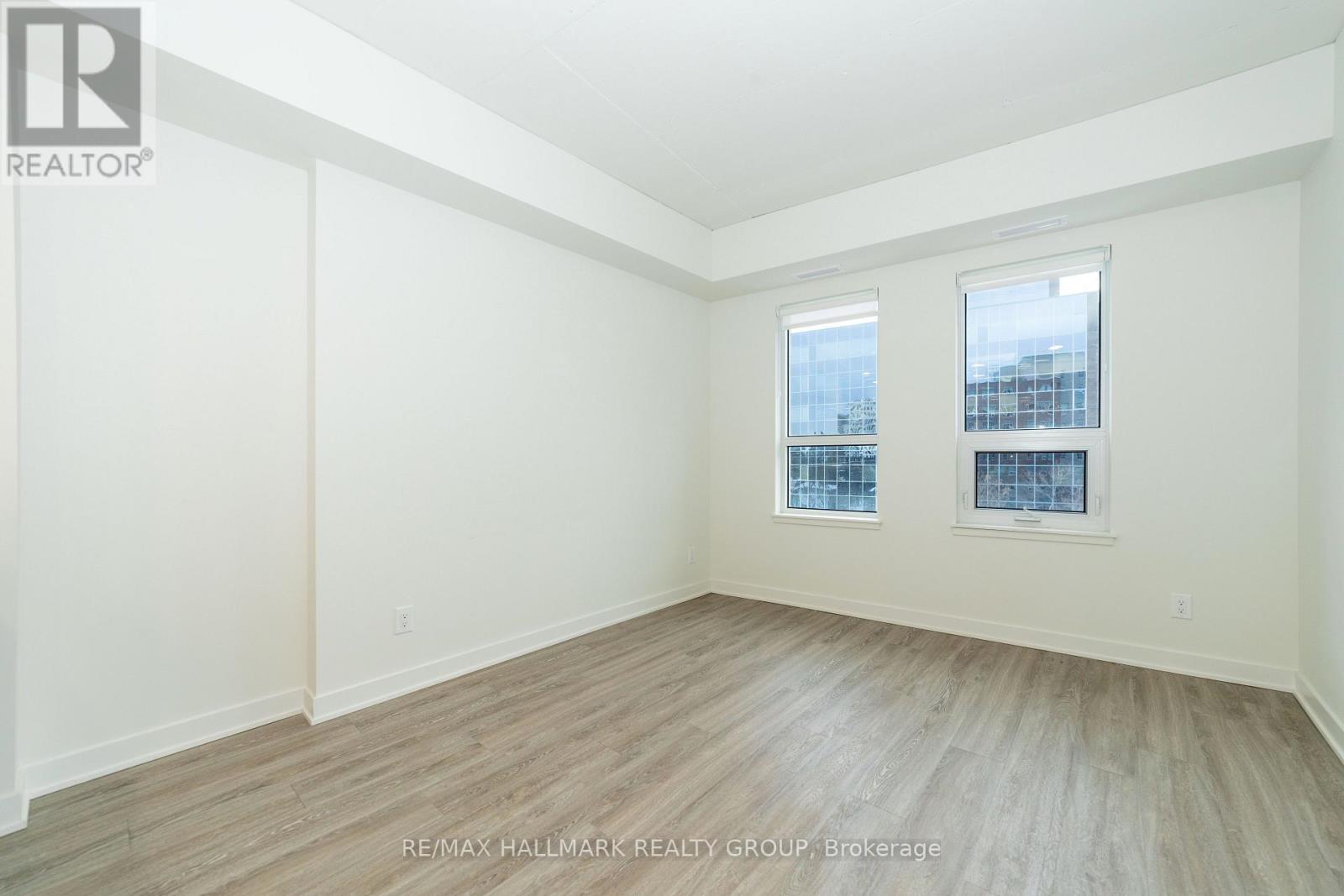 A room with a window and a wooden floor.