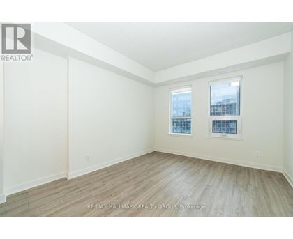 A room with a window and a wooden floor.