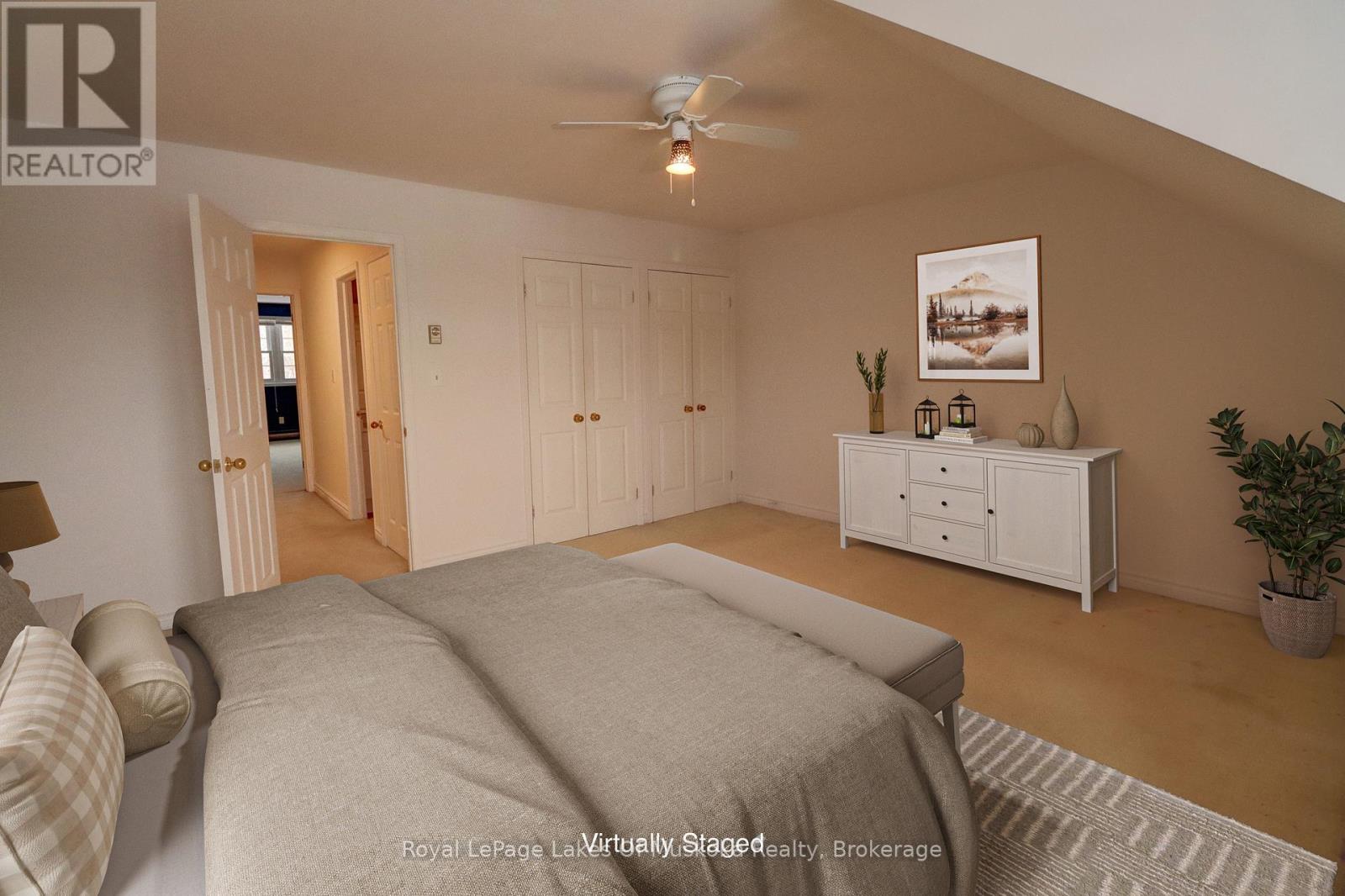 A bedroom with a bed, dresser, and ceiling fan.