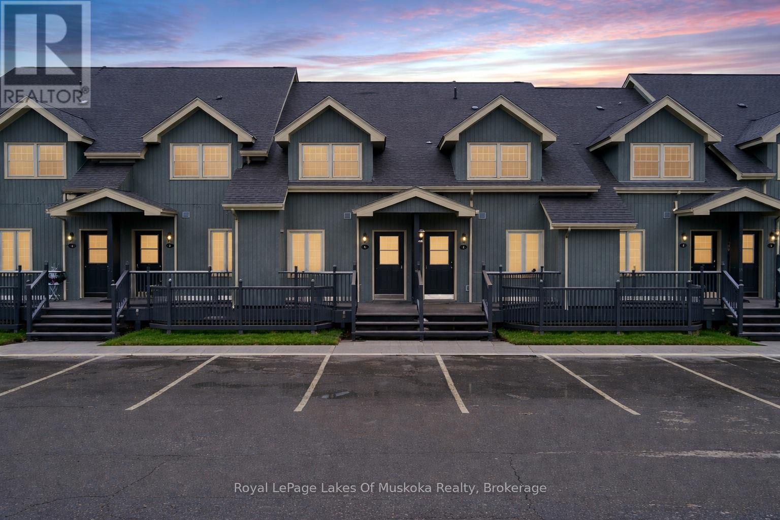 A building with the sign Royal LePage Lakes of Muskoka Realty, Brokerage in front of it.