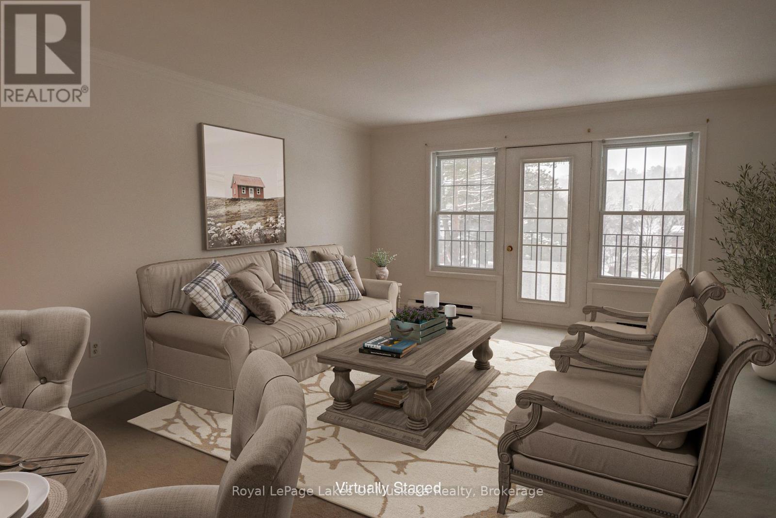 A living room with a couch, chairs, and a coffee table.
