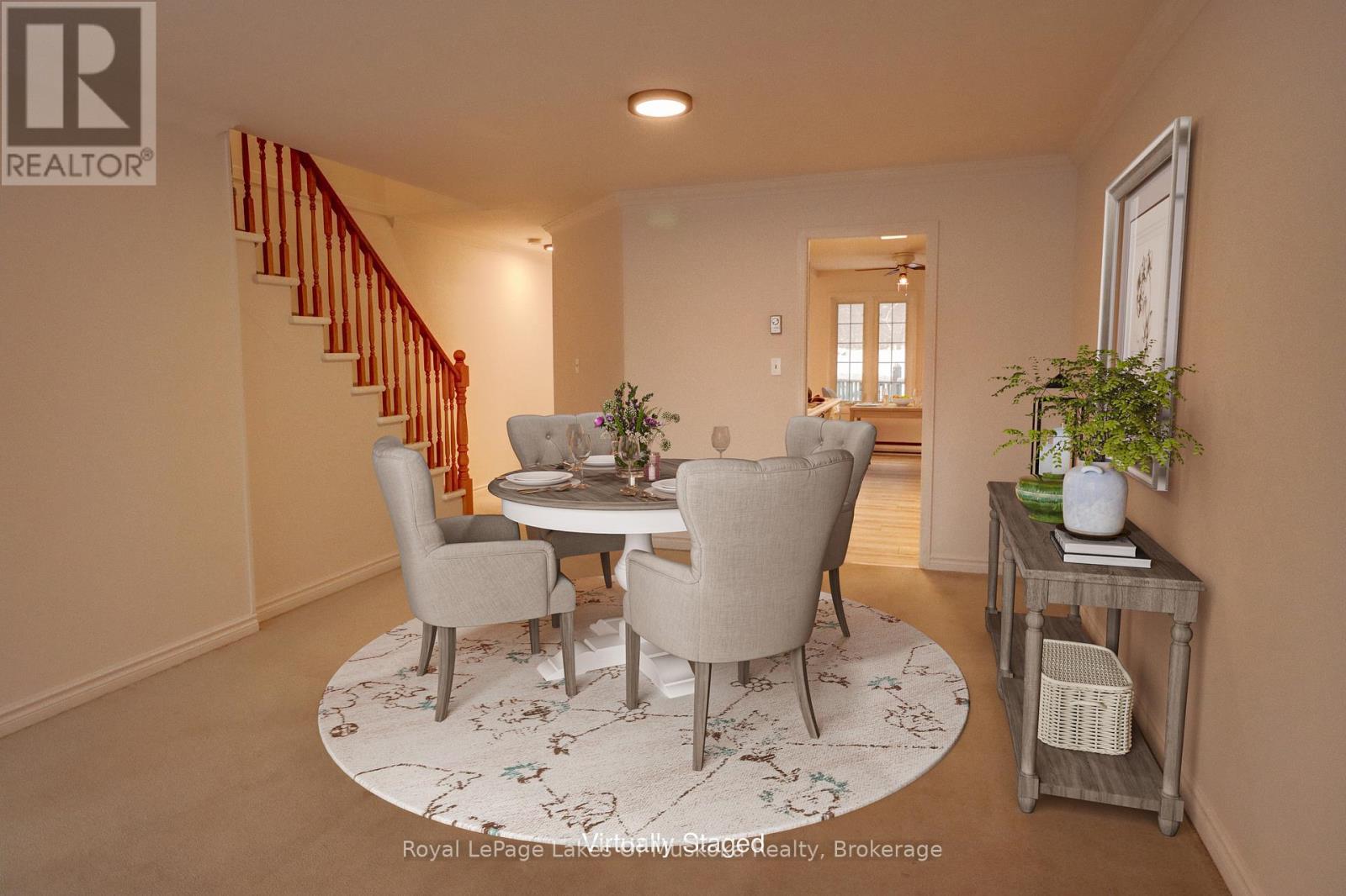 A dining room with a round table and chairs.