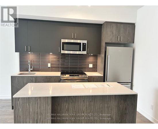A kitchen with a counter top and a microwave above it.