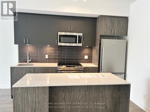 A kitchen with a counter top and a microwave above it.