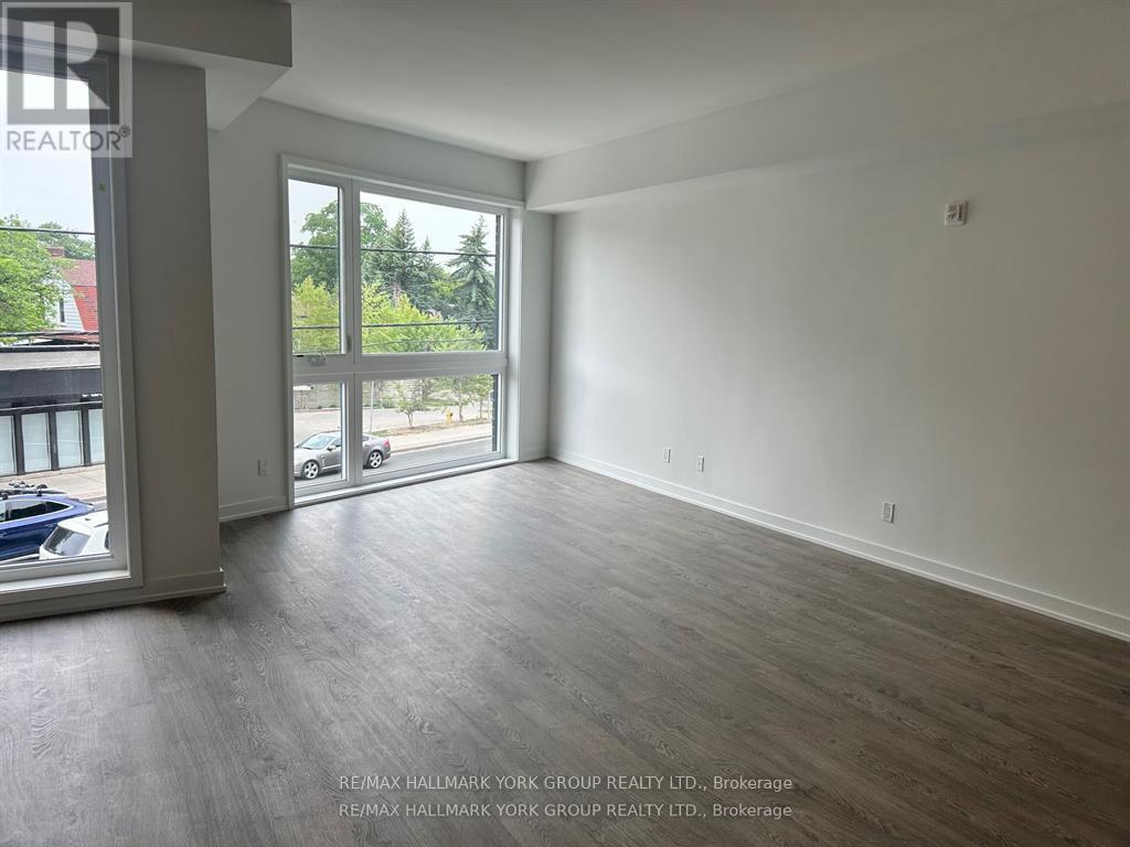 A spacious room with a view of the outside through a large window.