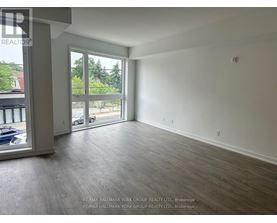A spacious room with a view of the outside through a large window.