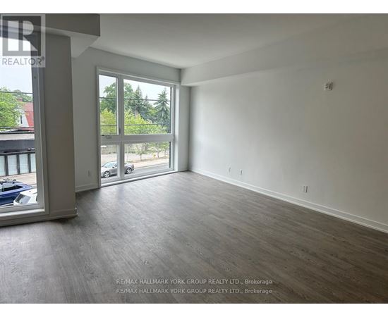 A spacious room with a view of the outside through a large window.