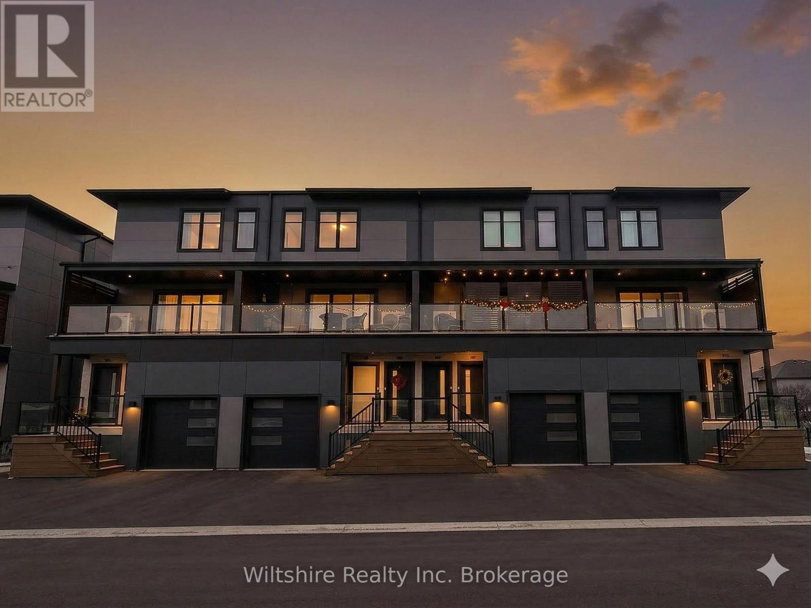 A modern building with the logo REALTOR on the top left corner.