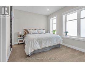 A bedroom with a large bed and a window.