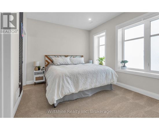 A bedroom with a large bed and a window.