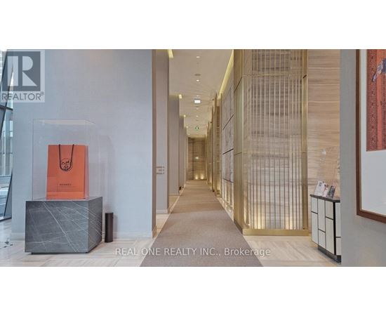 A hallway with a sign that says Real One Realty Inc. Brokerage.