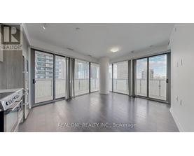 A spacious, empty room with large windows and sliding glass doors.