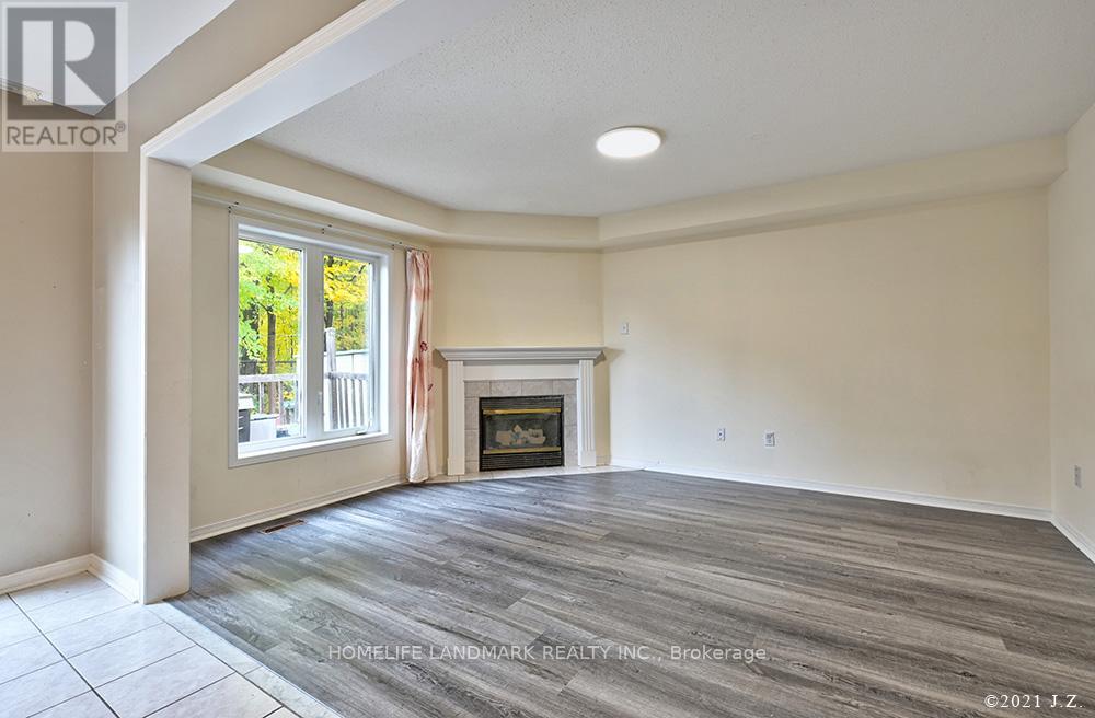 A living room with a fireplace and a large window.