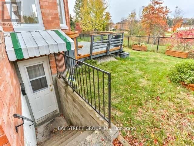 A small yard with a fence and a small tree.