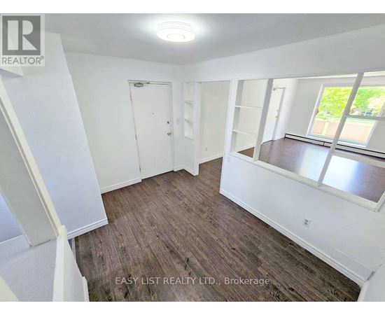 A small kitchen with white appliances and cabinets.