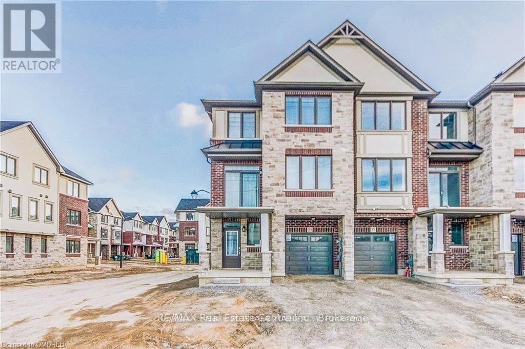 A real estate photograph of a residential area with houses and a sign that says REALTOR.