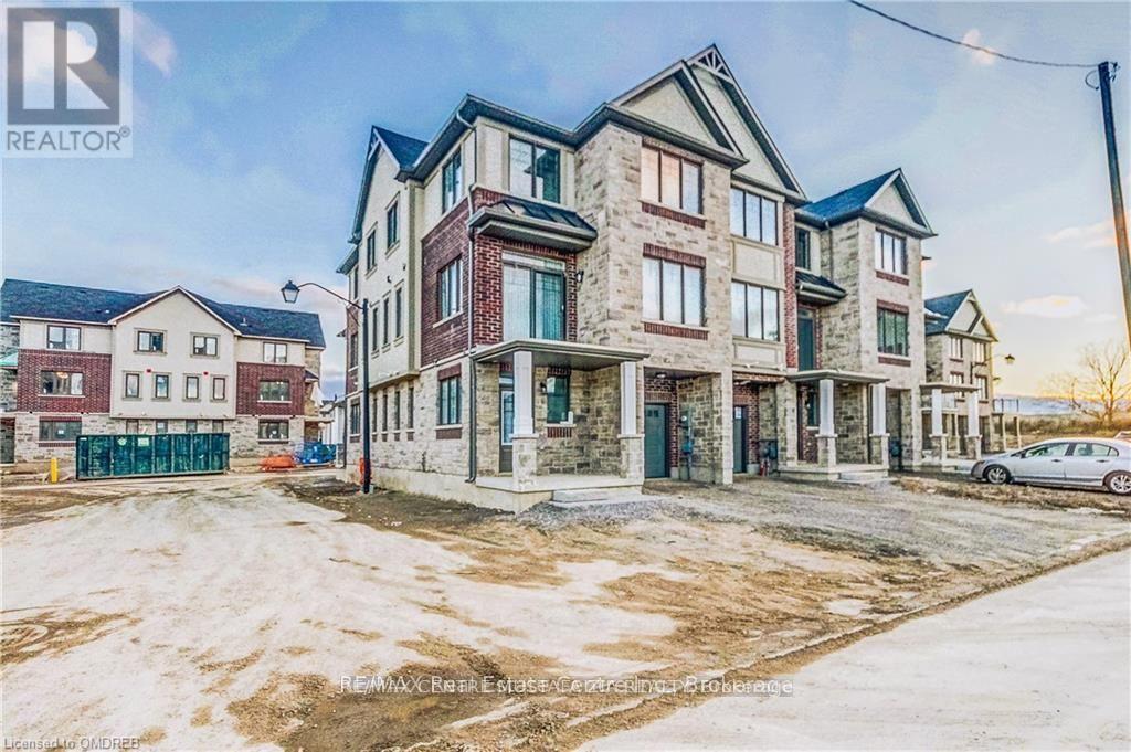 A large, multi-story residential building with a mix of brick and stone exterior.