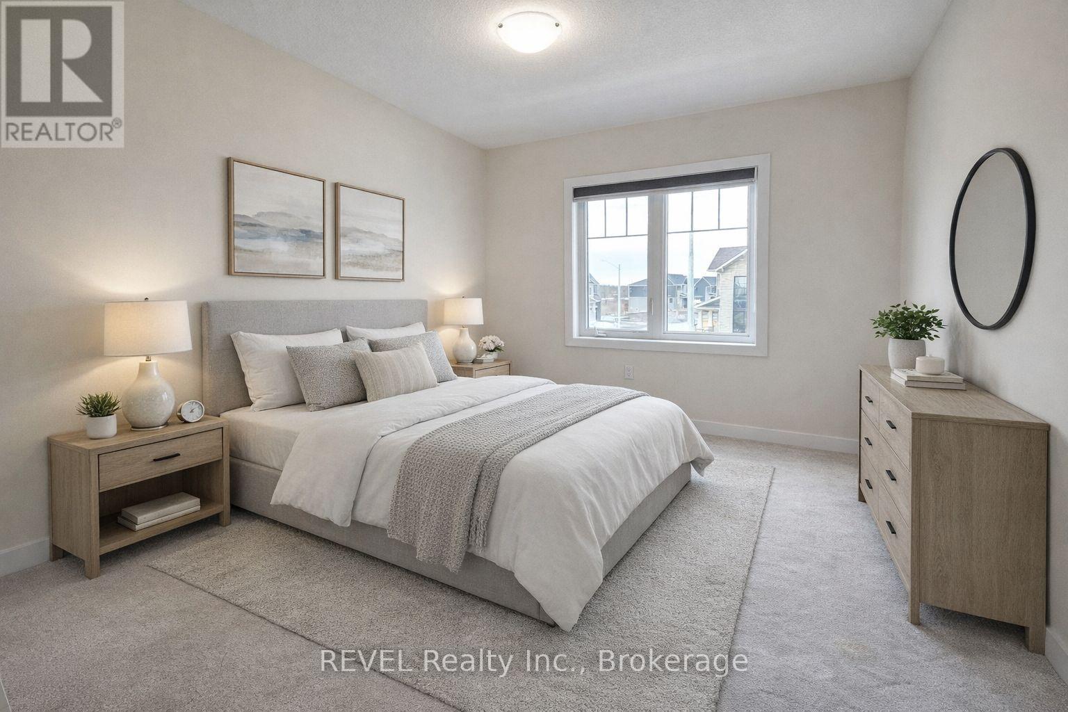 A bedroom with a large bed, nightstands, and a window.