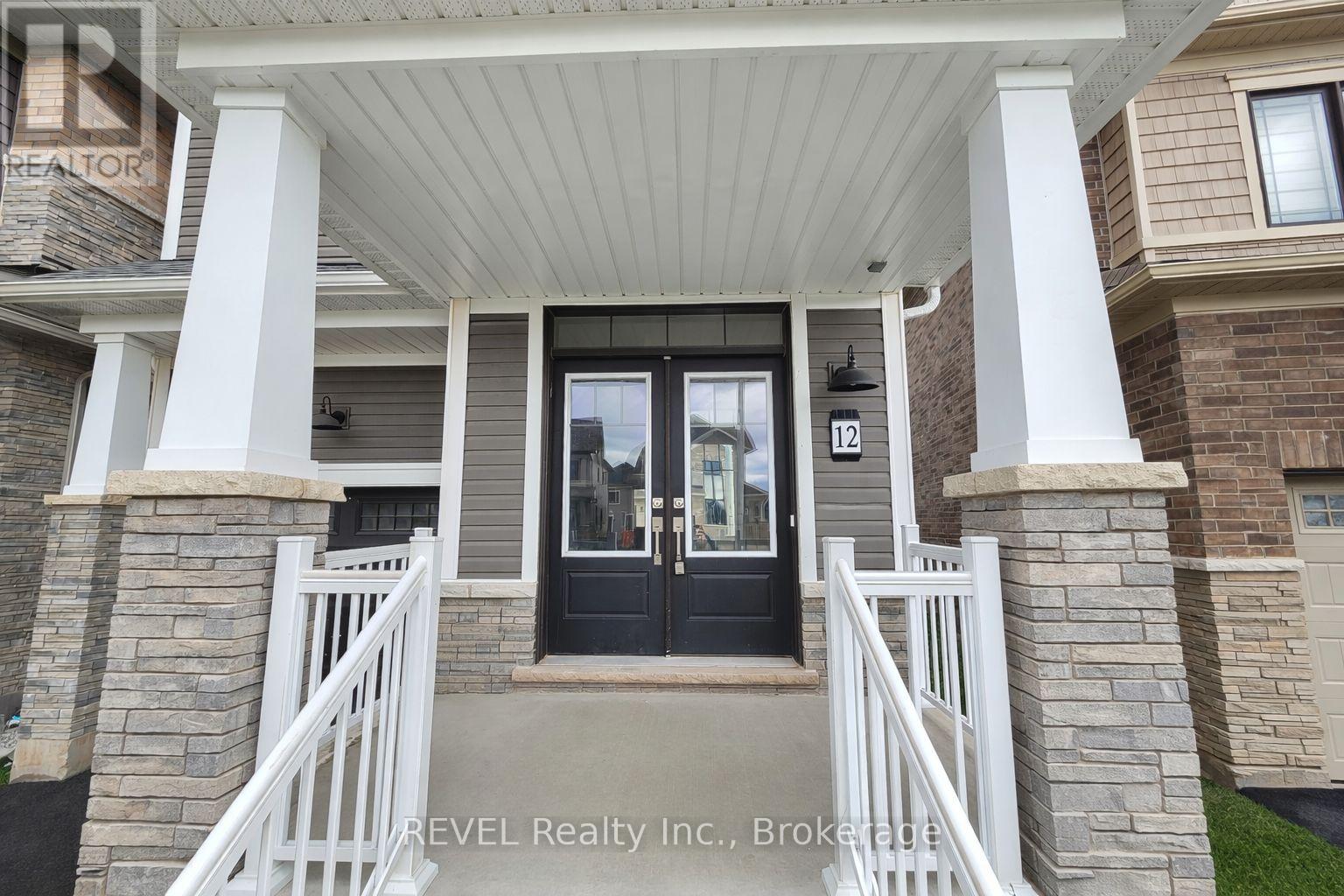 A house entrance with a black door and a white railing.