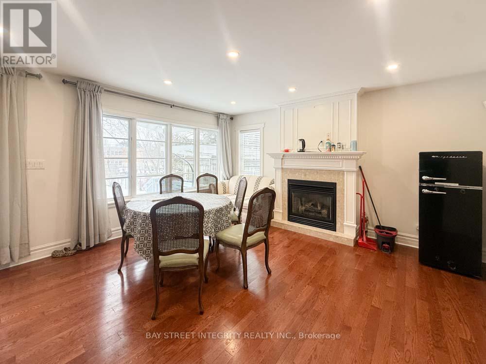 A dining room with a table set for four with chairs around it.
