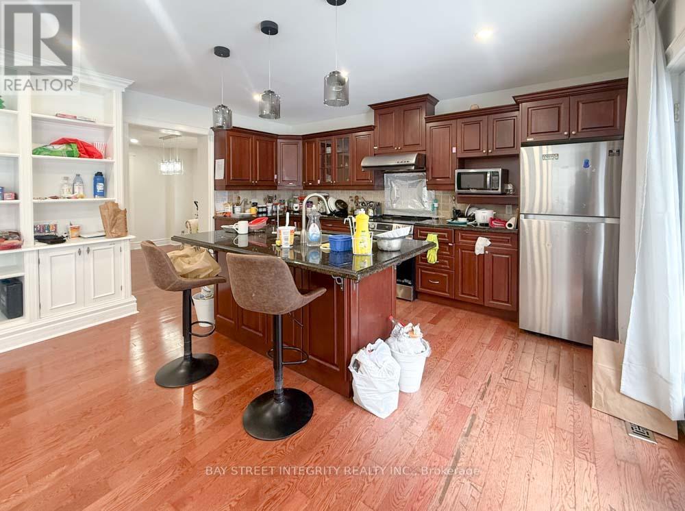 A kitchen with wooden floors and a center island.