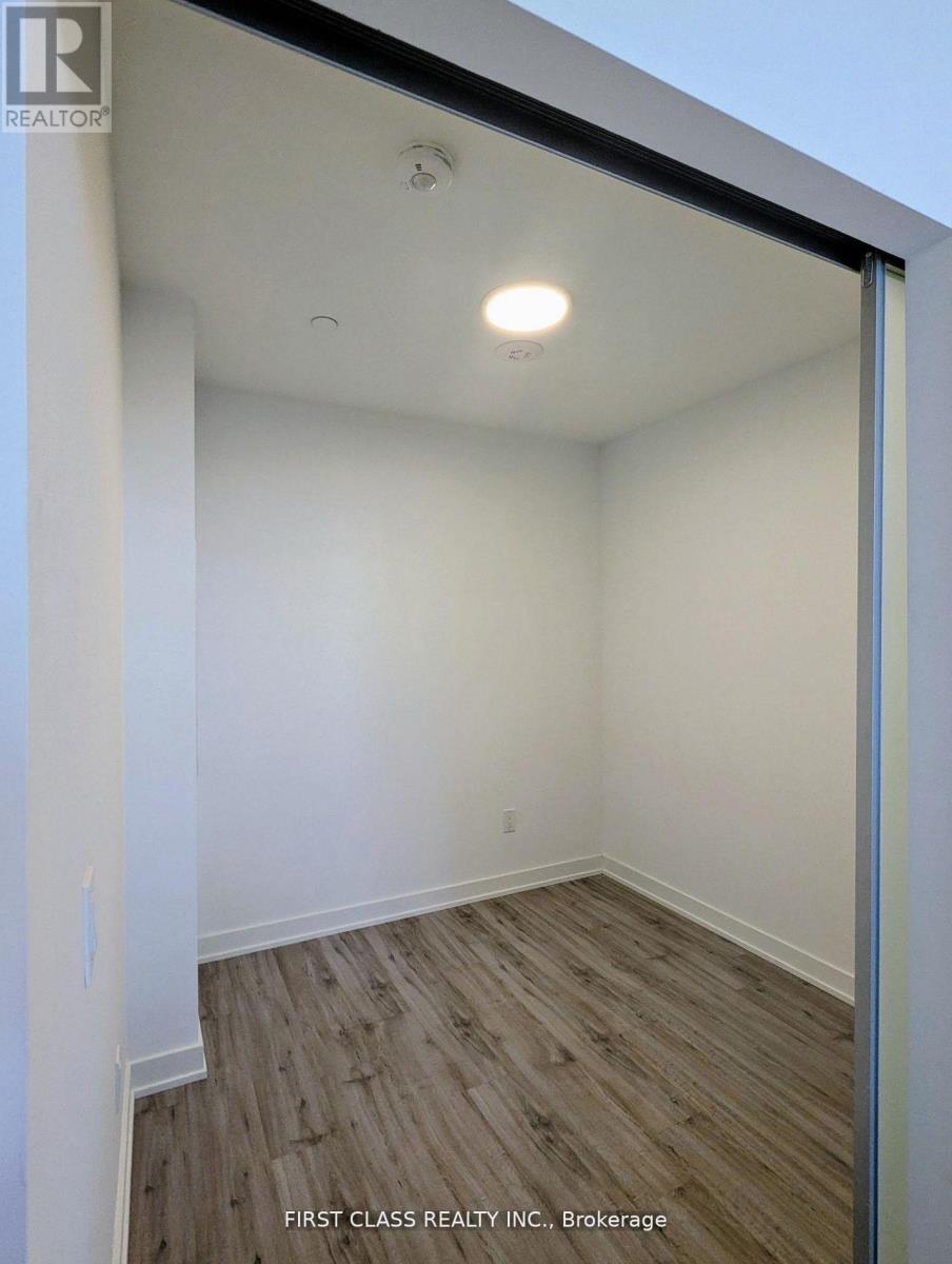 A room with wooden flooring and white walls.