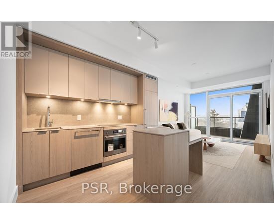 A modern kitchen with wooden cabinets and a large window.
