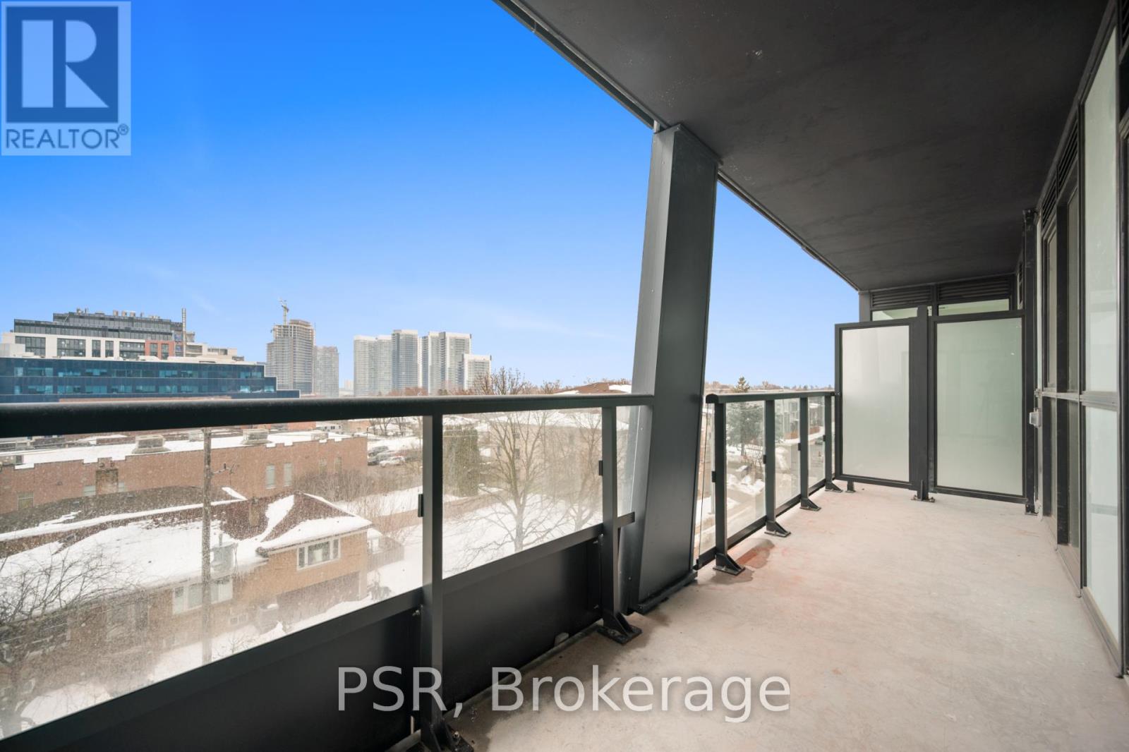 A balcony with a view of a cityscape and buildings.