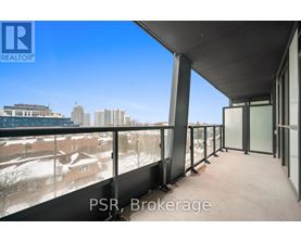 A balcony with a view of a cityscape and buildings.