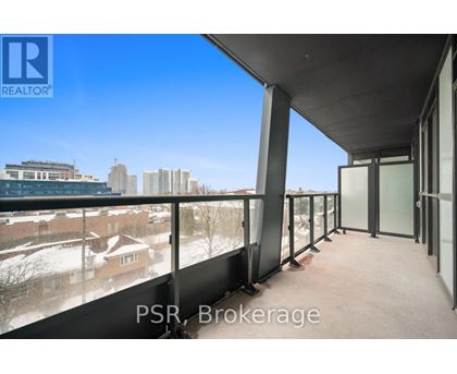 A balcony with a view of a cityscape and buildings.