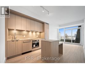 A modern kitchen with wooden cabinets and a large window.