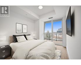 A bedroom with a large bed and a flat screen TV mounted on the wall.