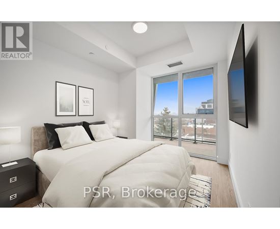 A bedroom with a large bed and a flat screen TV mounted on the wall.