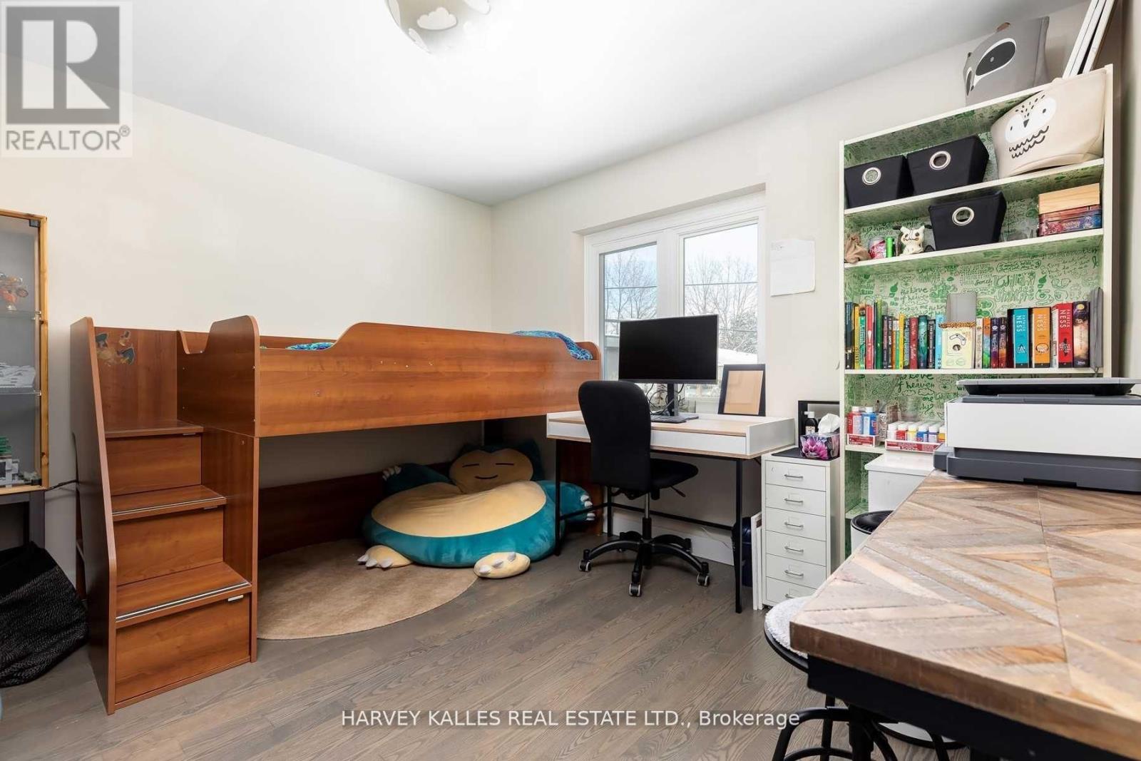 A bedroom with a bunk bed and a desk with a chair.