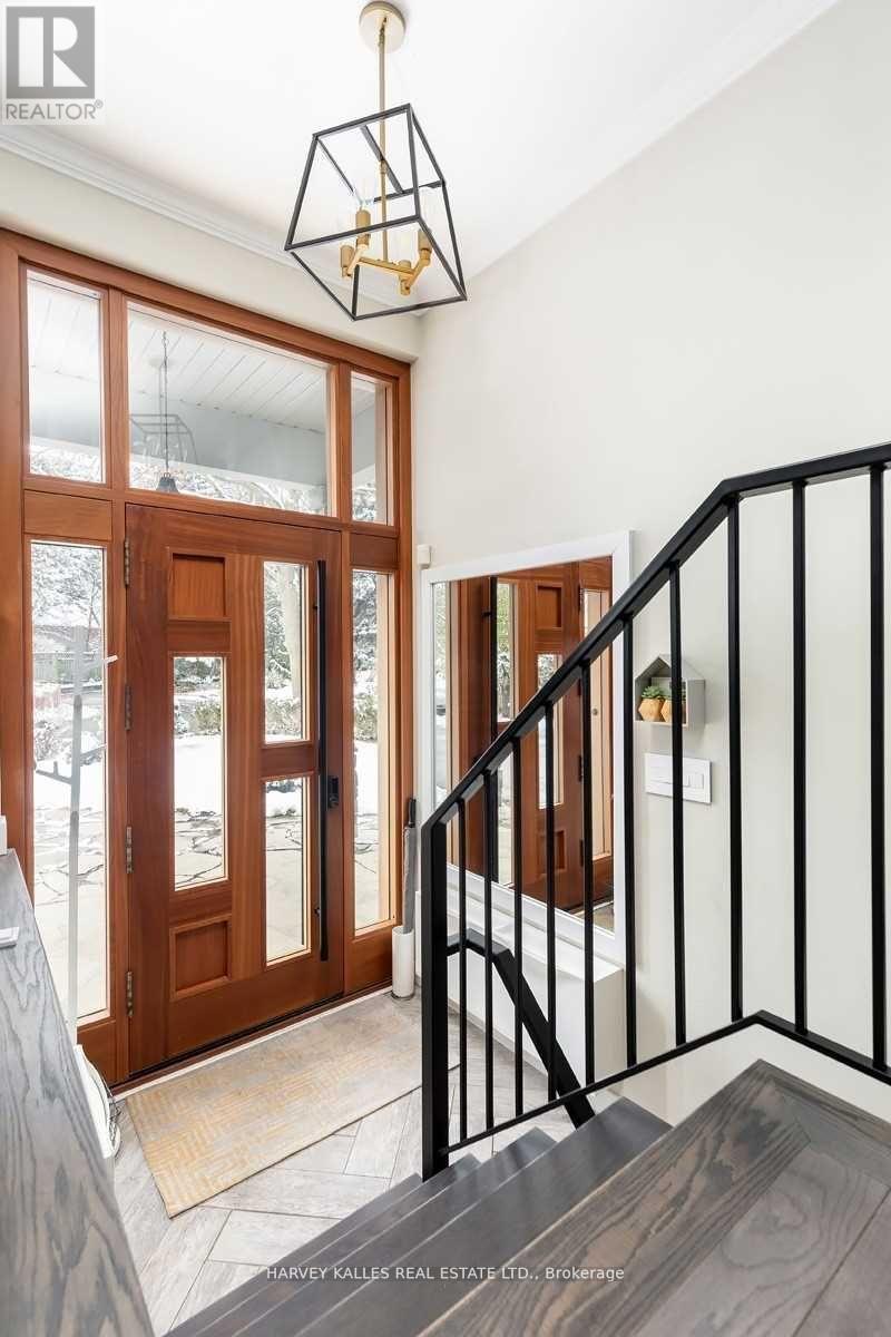 A staircase with a black railing and a wooden handrail.