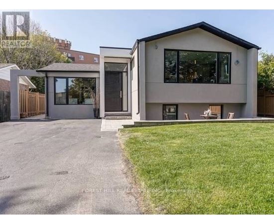 A modern house with a grey exterior and a black roof.