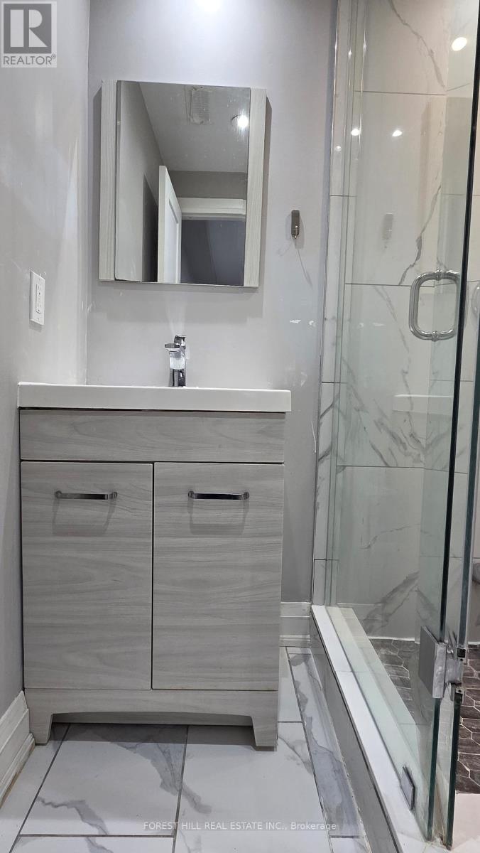 A bathroom with a sink, mirror, and cabinets.