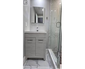 A bathroom with a sink, mirror, and cabinets.