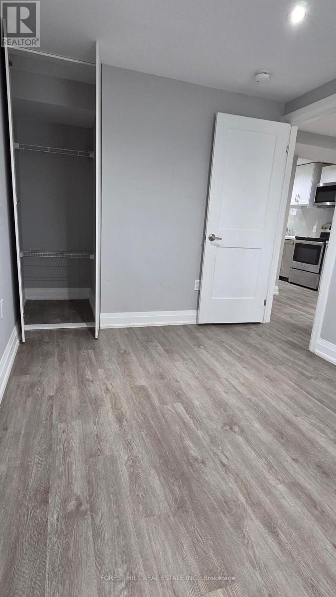 A kitchen area with a refrigerator, microwave, and oven.