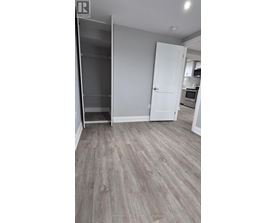 A kitchen area with a refrigerator, microwave, and oven.