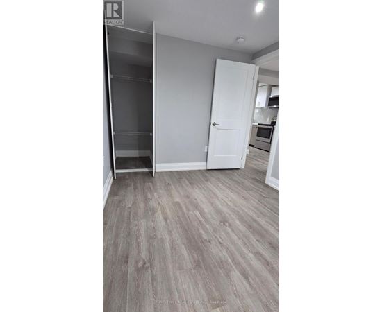 A kitchen area with a refrigerator, microwave, and oven.