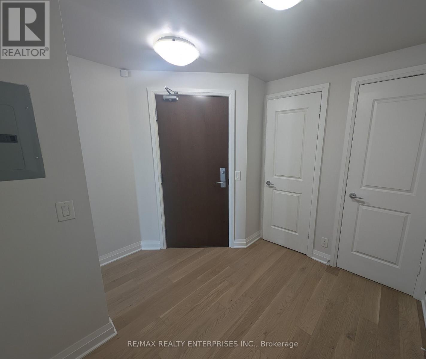 A room with a brown door and white walls.