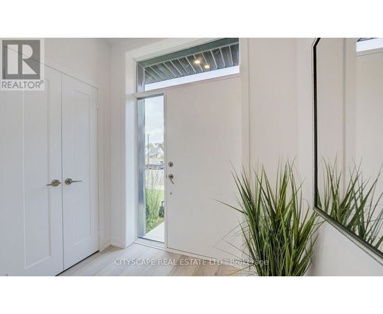 A realtor logo is on the wall in a white room.