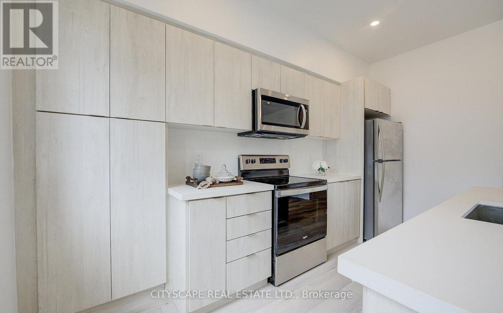 A modern kitchen with a white countertop and a black oven.
