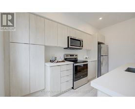 A modern kitchen with a white countertop and a black oven.
