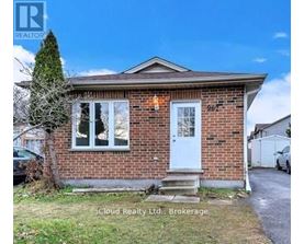 A small brick house with a white door and windows is for sale.